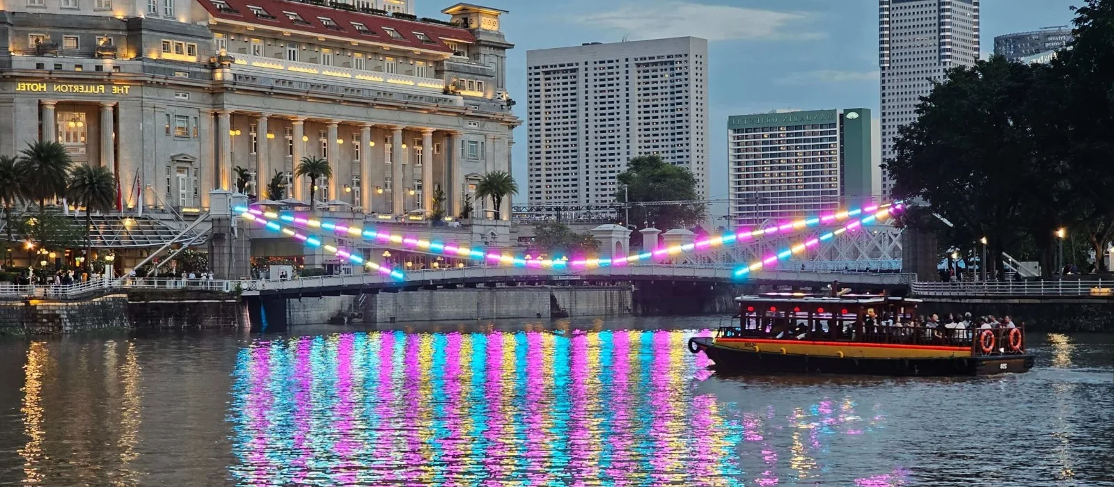 The Singapore River at night beside Boat Quay
