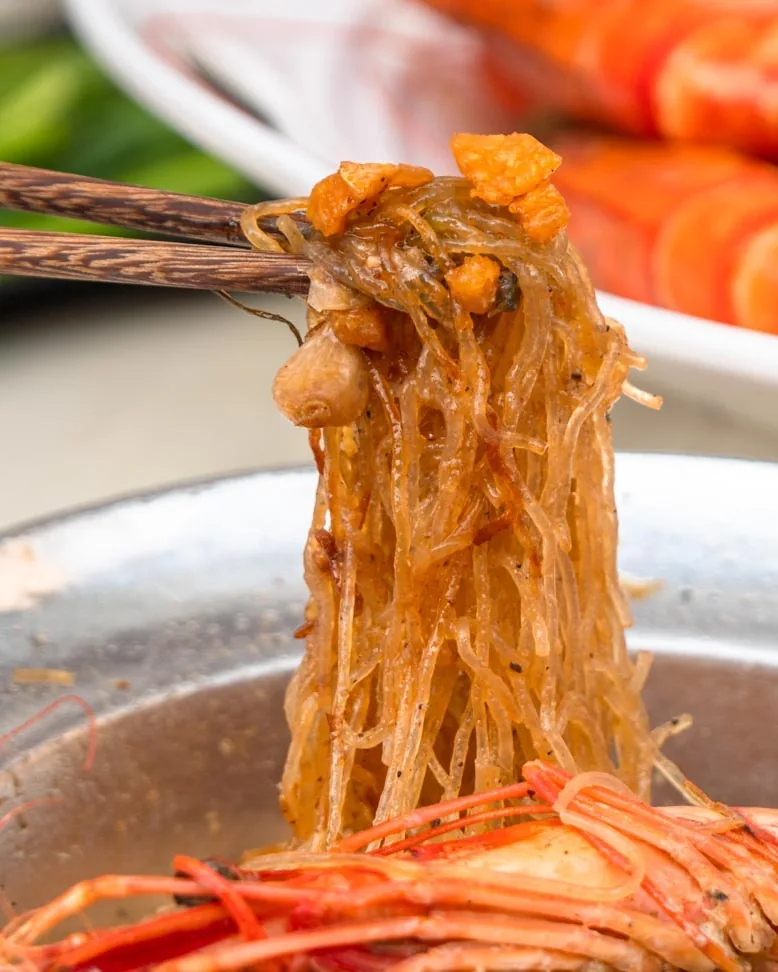 Thai seafood vermicelli lifted from the steelpot